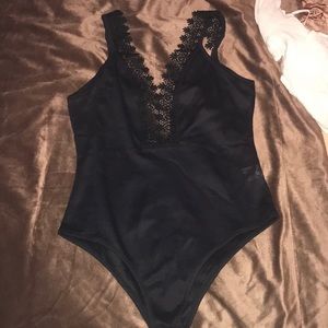 Black H&M Bodysuit top with lace trim. Tried on but never worn out.